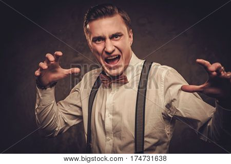 Sharp dressed man wearing bow tie showing emotions.