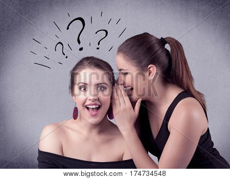 A teenager girl looking confused with drawn question marks above the head, while a girlfriend whispers something in her ear concept.