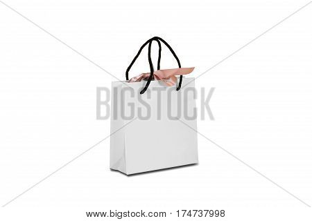 Blank White Paper Gift Bag With A Bow Mock Up Standing On A Wooden Table. Empty Plastic Package Mock