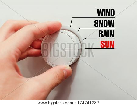 Male Hand Turns The Switch. Switches Weather. Chose The Sun.