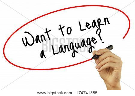 Man Hand Writing Want To Learn A Language? With Black Marker On Visual Screen. Isolated On Backgroun