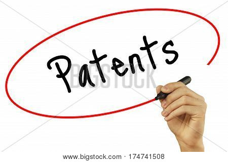 Man Hand Writing Patents With Black Marker On Visual Screen. Isolated On Background. Business, Techn