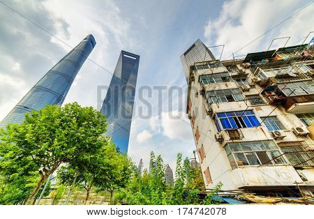 Old House Surrounded Modern Skyscrapers In Shanghai, China