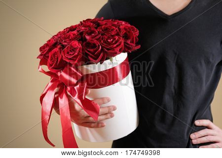 Man In Black T Shirt Holding In Hand Rich Gift Bouquet Of 21 Red Roses. Composition Of Flowers In A