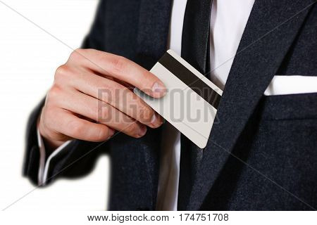Smartly Dressed Business Man Putting A Credit Card Into His Pocket. Man In A Black Suit, White Shirt