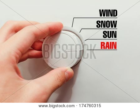 Male Hand Turns The Switch. Switches Weather. Chose The Rain.