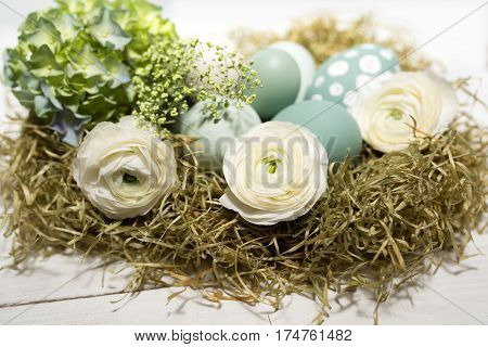 Tender easter decoration with pastel colored eggs and flowers in vintage style