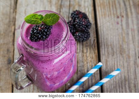 Blackberry jogurt smoothie in glass jar, copy space