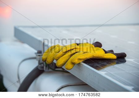 old dirty work gloves yellow on solar panel