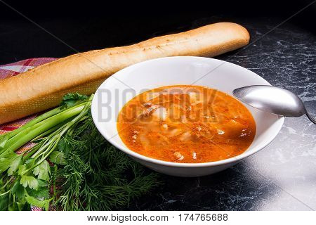 Vegetables And Meat In Red Beetroot Soup Or Borsch In White Plate On Dark Marble Background.