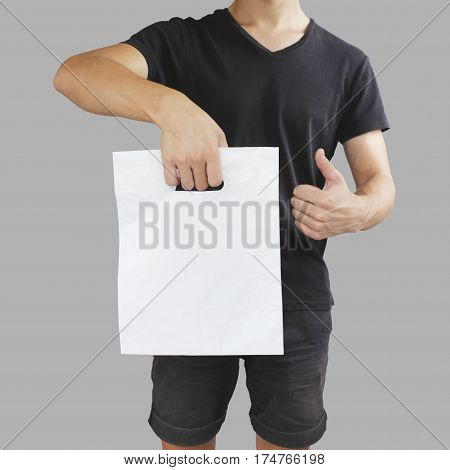Man Shows Blank Plastic Bag Mock Up And Thumb Up Isolated. Empty White Polyethylene Package Mockup.