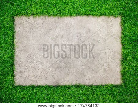 Square concrete plate on artificial green grass background