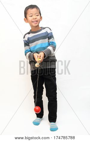 Japanese Boy Playing Cup And Ball (first Grade At Elementary School)