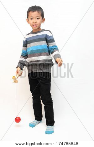 Japanese Boy Playing Cup And Ball (first Grade At Elementary School)