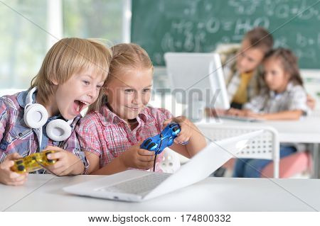 Portrait of brother and sister playing video game