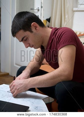 Photographing Danila Mazić in a tight red shirt and black pants while drawing construction plans, Novi Sad, Serbia