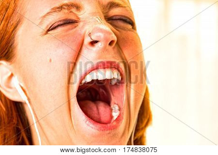 Young Redhead Girl With Mouth Wide Open