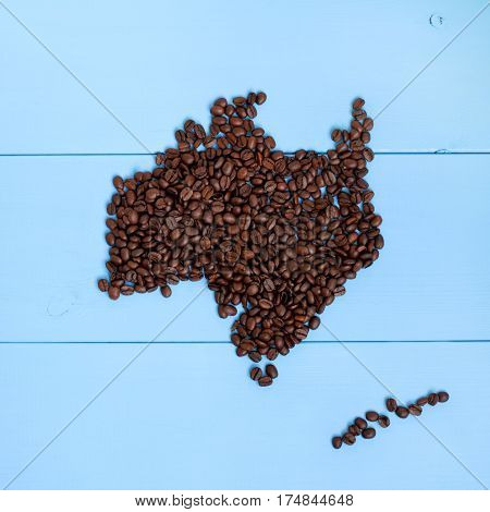 flat concept made of coffee beans lying on a blue table top view / Australia and New Zealand