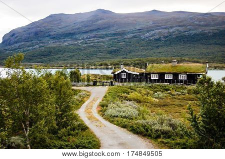 typical wooden turf house in a norway fjord