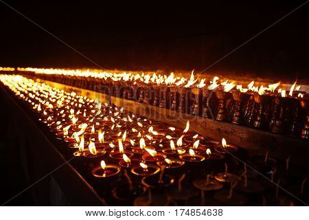 Many Candle Flames Glowing In The Dark