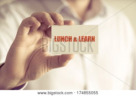 Businessman Holding Lunch And Learn Message Card