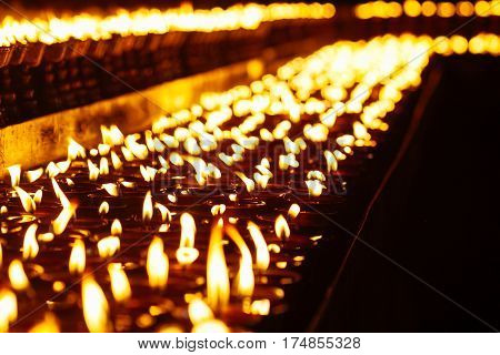 Many Candle Flames Glowing In The Dark