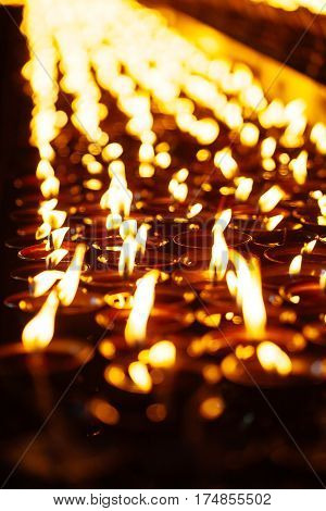 Many Candle Flames Glowing In The Dark
