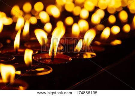 Many Candle Flames Glowing In The Dark