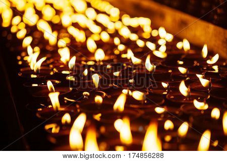Many Candle Flames Glowing In The Dark