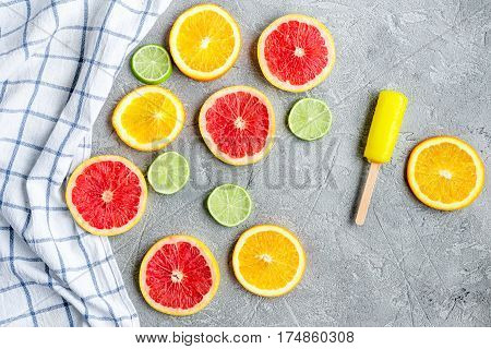 Homemade orange icecream with fresh fruits on stone table background top view
