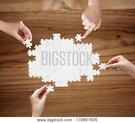 Hand Holding A Piece Of White Uncompleted Puzzle