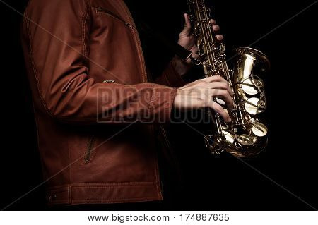 male jazz saxophone player on the stage with brown leather jacket