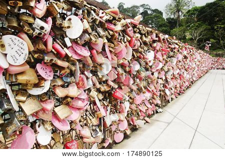 Lovers Person Showing Love By Use Master Key Lock On Steel Net At Love Lock Penang Hill