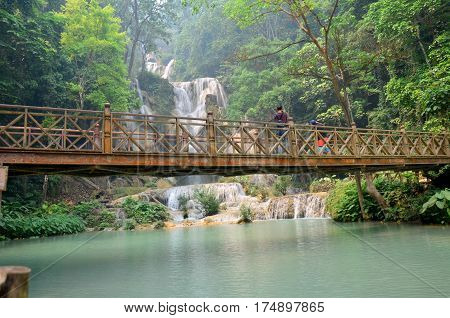 People Travel And Stand On The Bridge Looking And Take Photo Viewpoint Of Kuang Si Falls