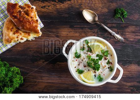 Avgolemono, Chicken Soup With Egg-lemon Sauce, Rice And Fresh Parsley Leaves In White Bowl And Fresh
