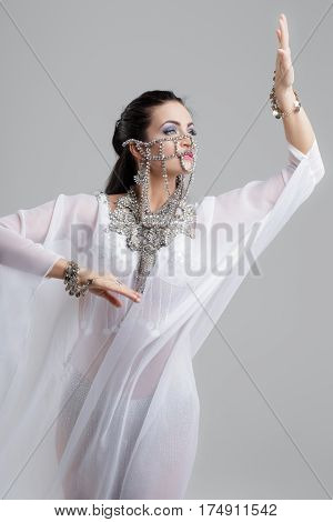Sexy oriental arabic belly dancer dancing in silk weil outfit