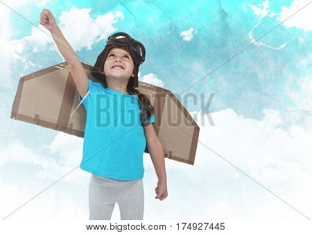 Dgital composite of smiling kid pretending to be a pilot against clouds