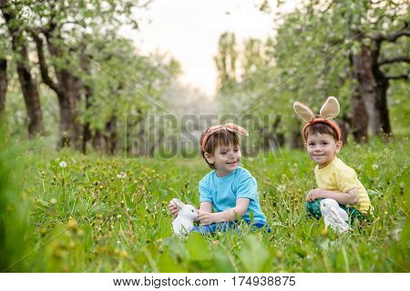 Two Little Kids Boys And Friends In Easter Bunny Ears During Tra