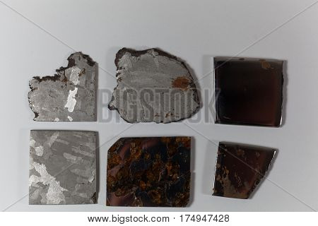 Iron meteorite pieces on a white background.