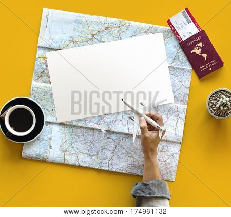 Hand holding toy airplane and planning travel destination