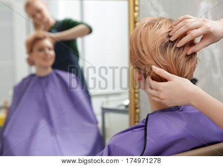 Hairdresser working with client at salon
