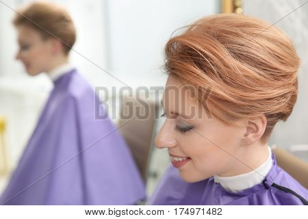 Young woman with trendy hairstyle at beauty salon