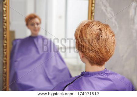 Young woman with trendy hairstyle at beauty salon