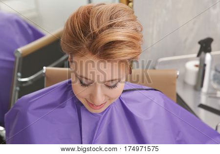Young woman with trendy hairstyle at beauty salon