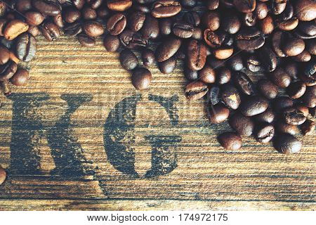 Beans coffe with wooden texture. Raw coffe with symbol weight in grams.