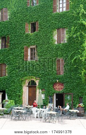 Neive Italy - 17 July 2010: People talking and drinking at a wine bar of Neive in Piedmont Italy