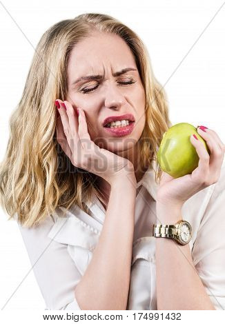 Woman feels toothpain because of sensitive gums and eating green apple.