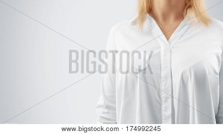 Blank button badge mockup pinned on the womans chest, close up view. Girl wear white shirt and campaign pin mock up. Volunteer round emblem design element. Pesron stand front view with voting symbol