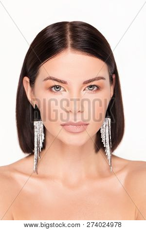 Beautiful Girl Wearing Diamonds Earrings, Posing On A White Background.
