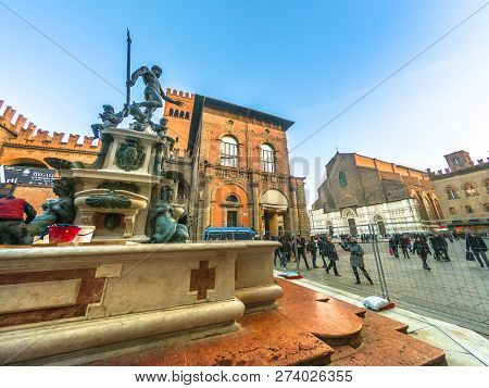 Bologna, Italy - December 7, 2018: Neptune 1500s Bronze Fountain. San Petronio Gothic Basilica And C